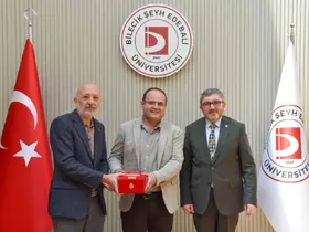 BŞEÜ’ye gümüş madalya ve madalya beratı takdimi
