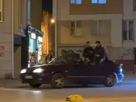 Seyir halindeki otomobillin bagajına ters oturan şahıs dikkat çekti
