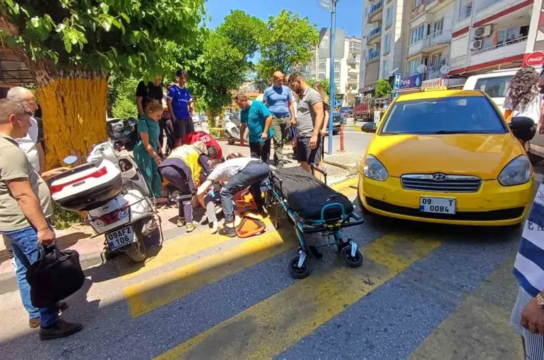 Efeler’de yolun karşısına geçmek isteyen kadına taksi çarptı: 1 yaralı
