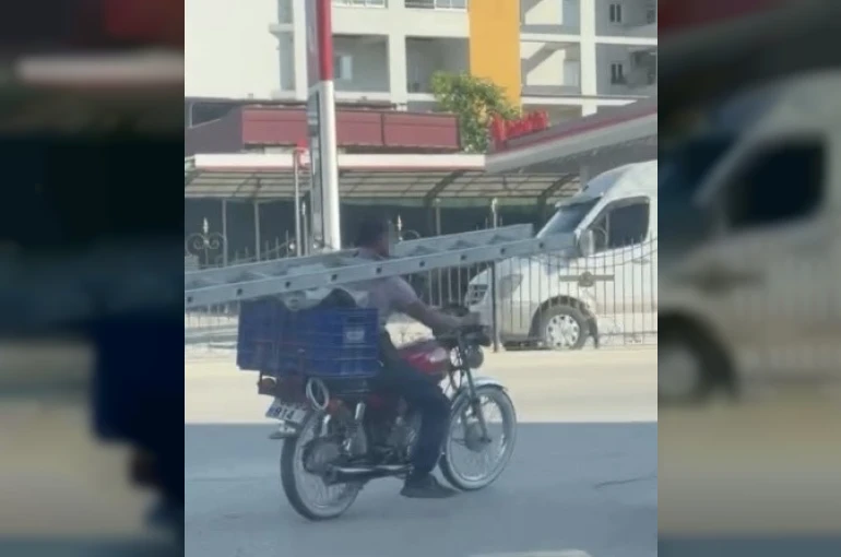 Boynunda merdivenle motosiklet kullandı