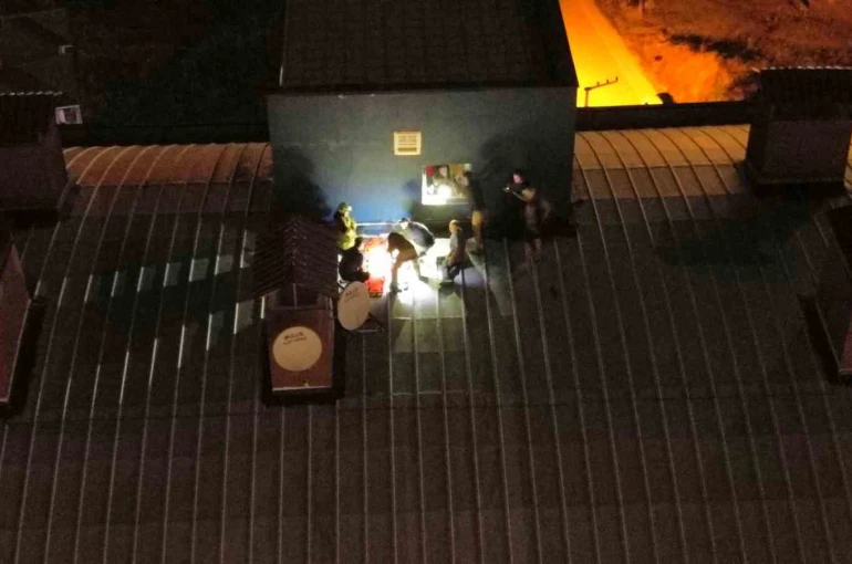 Genç kız çatıya çıktı, kurtarmak isteyenlerle birlikte mahsur kaldı 